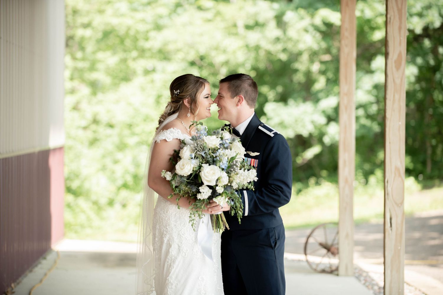 Romantic wedding moment captured under covered porch with white bouquet. Zimmerman MN Weddings