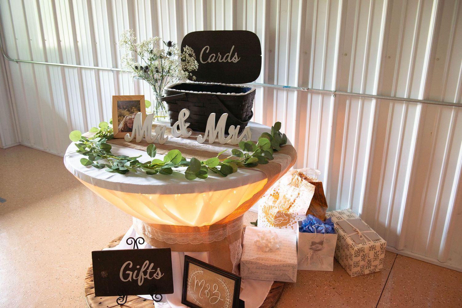 Wedding gift and cards table decorated with greenery and chalkboard signs at a rustic reception. Zimmerman MN Weddings