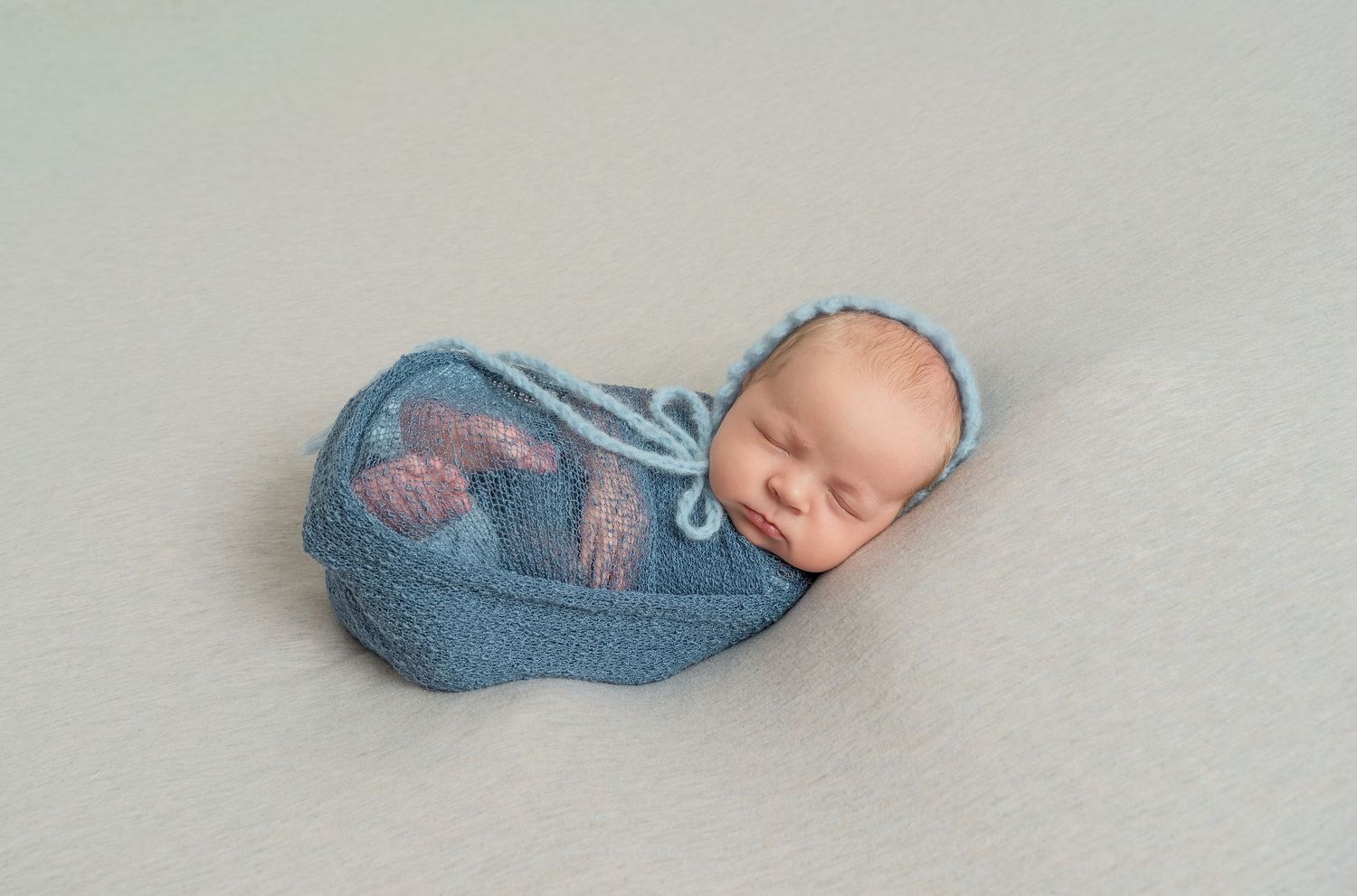 In central Minnesota a series of photos showing a sleeping baby nestled in soft denim clothing arranged in a creative composition.