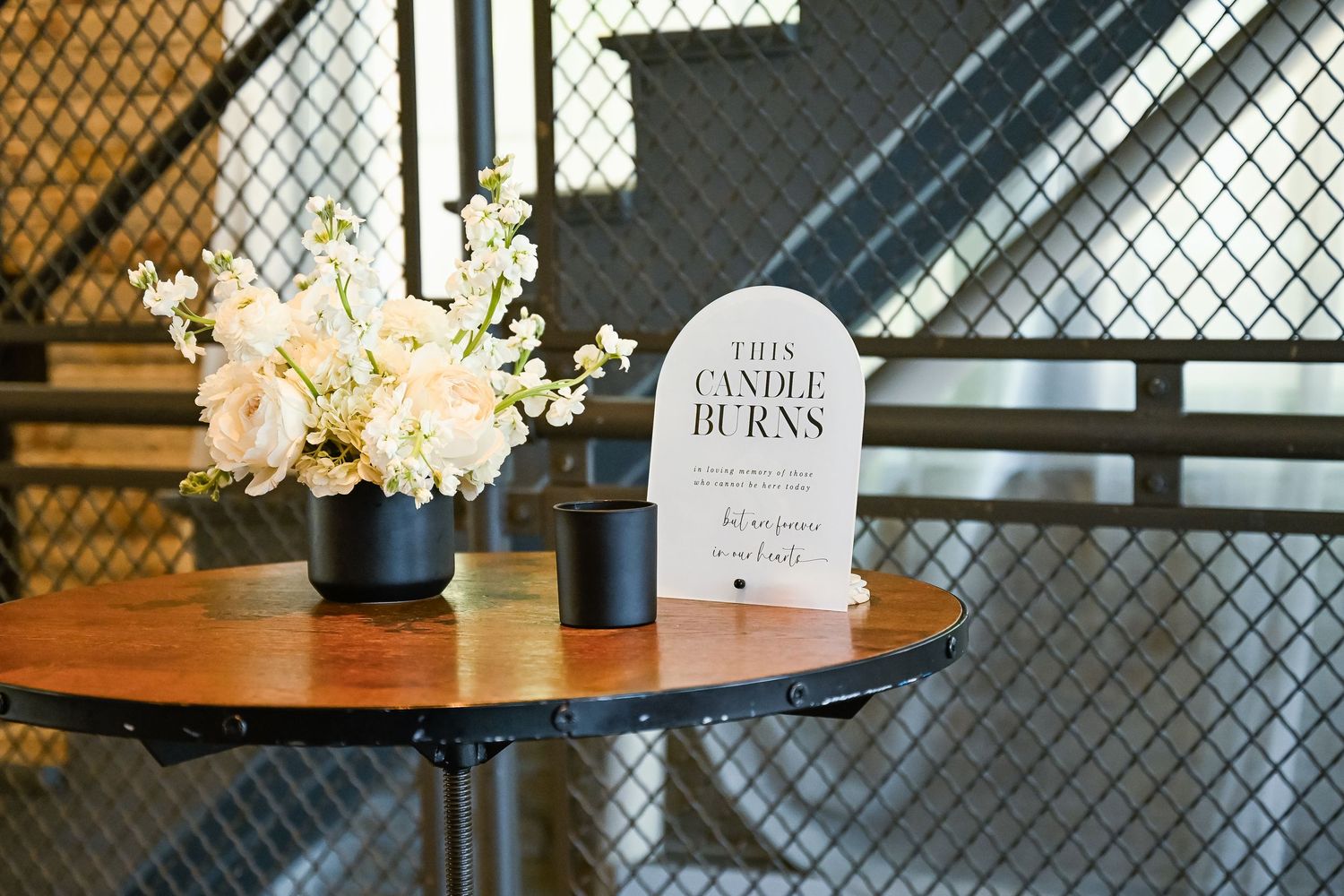Wedding venue detail showing industrial decor and table settings.