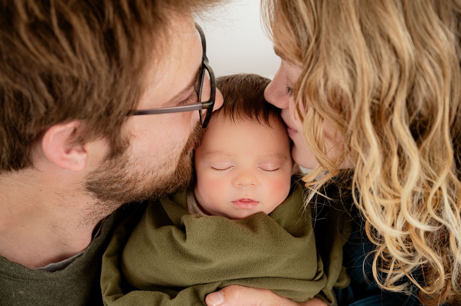 Minnesota Best newborn photographer - A tender close-up moment between a couple with soft natural lighting.