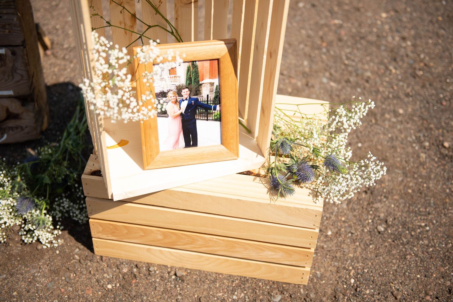 Wooden crate display boxes arranged as wedding decor on gravel surface. Zimmerman MN Weddings