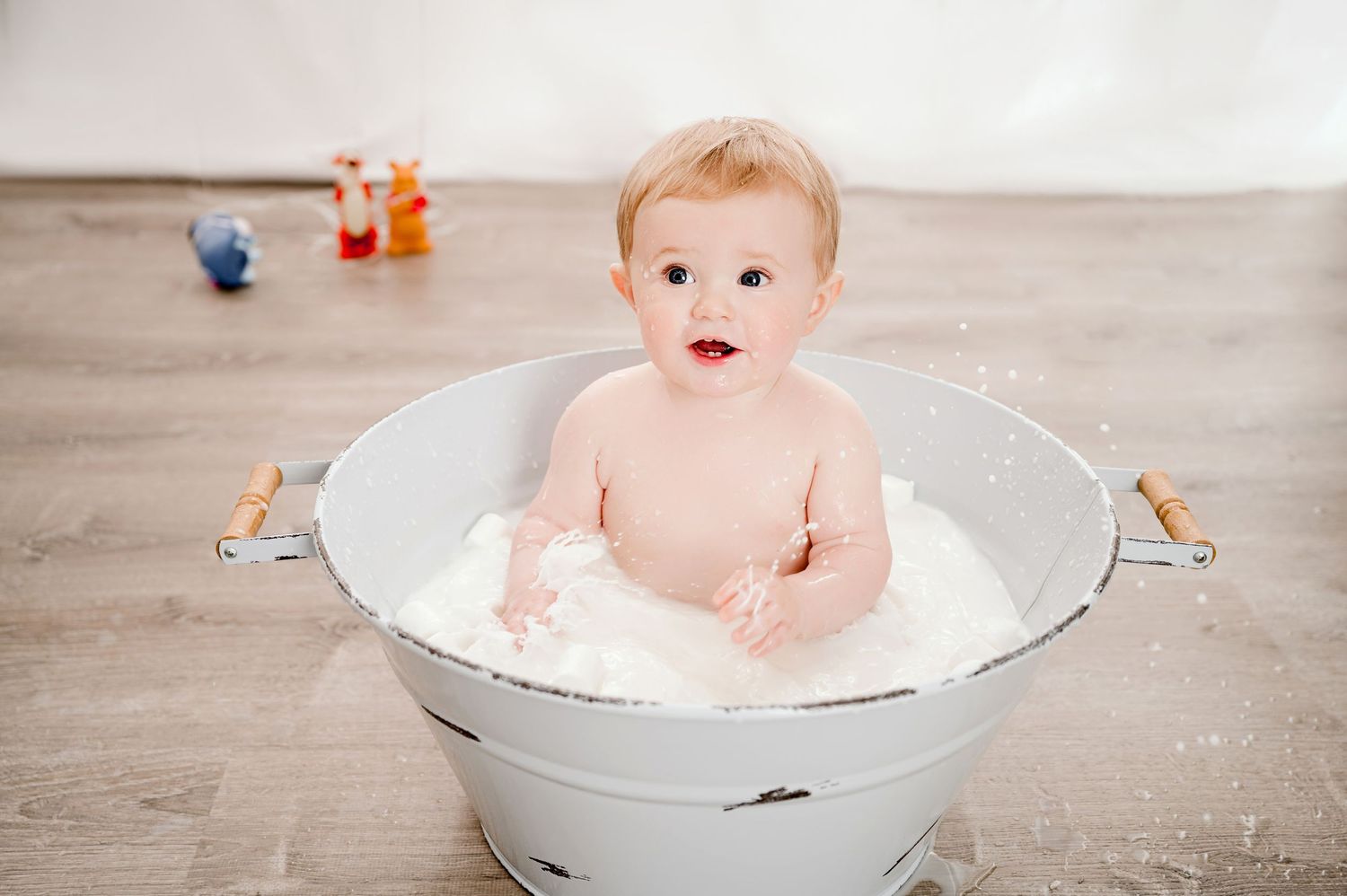 Central MN smash n splash Photography - Adorable baby boy sitting in vintage white metal tub with bubbles during bath time photo session.