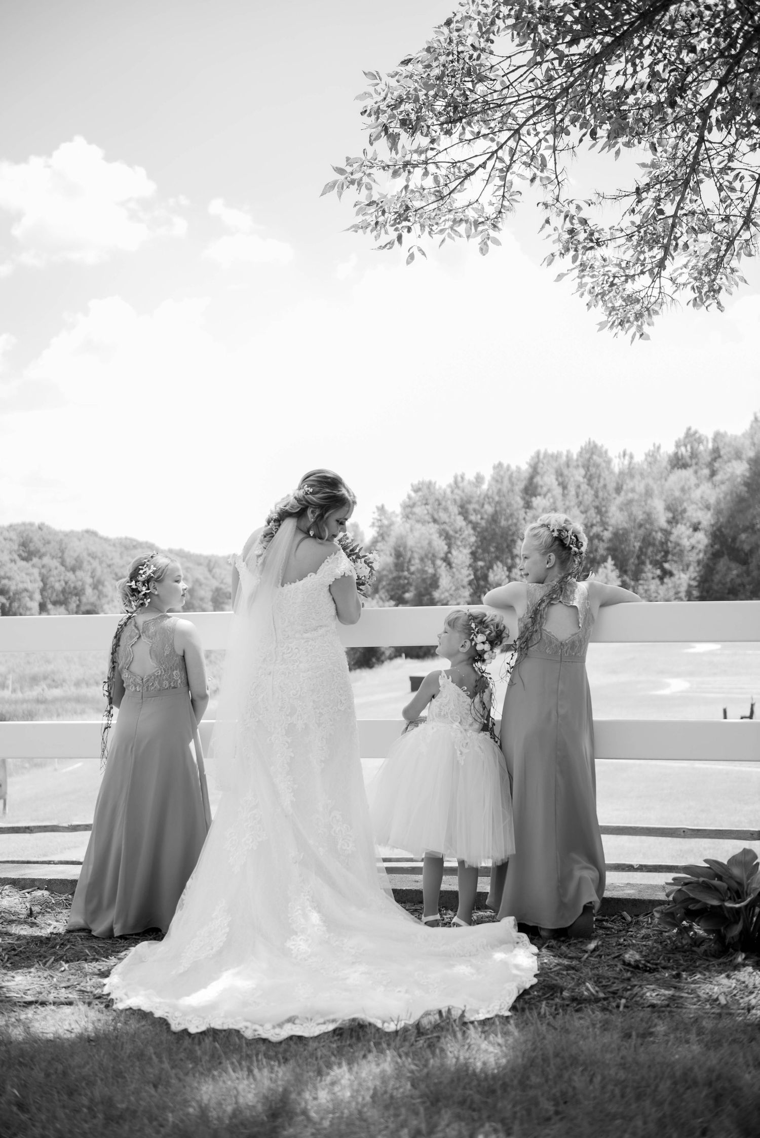 A serene wedding party portrait overlooking a lake with trees in black and white. Zimmerman MN Weddings