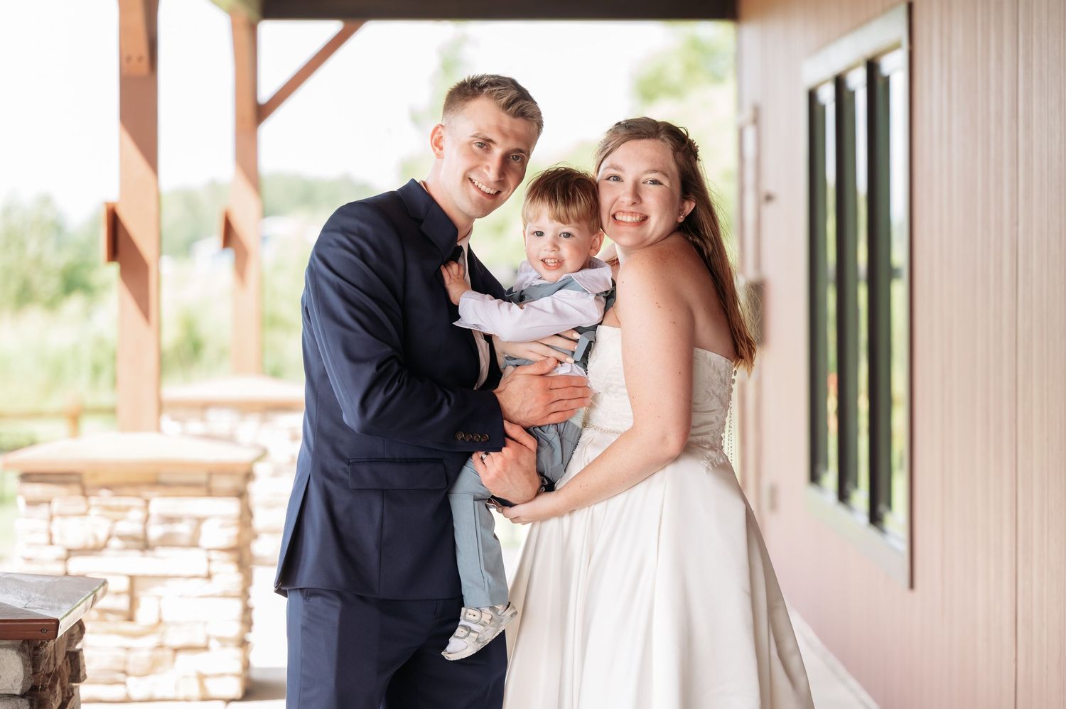 A couple dances together in a rustic venue with large windows and natural lighting. Pease Minnesota Wedding at Northern Lights Ballroom & Ba