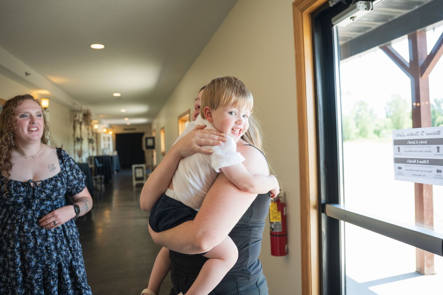 A sequence of photos showing two people embracing in a hallway with natural light coming through windows. Pease Minnesota Wedding at Norther