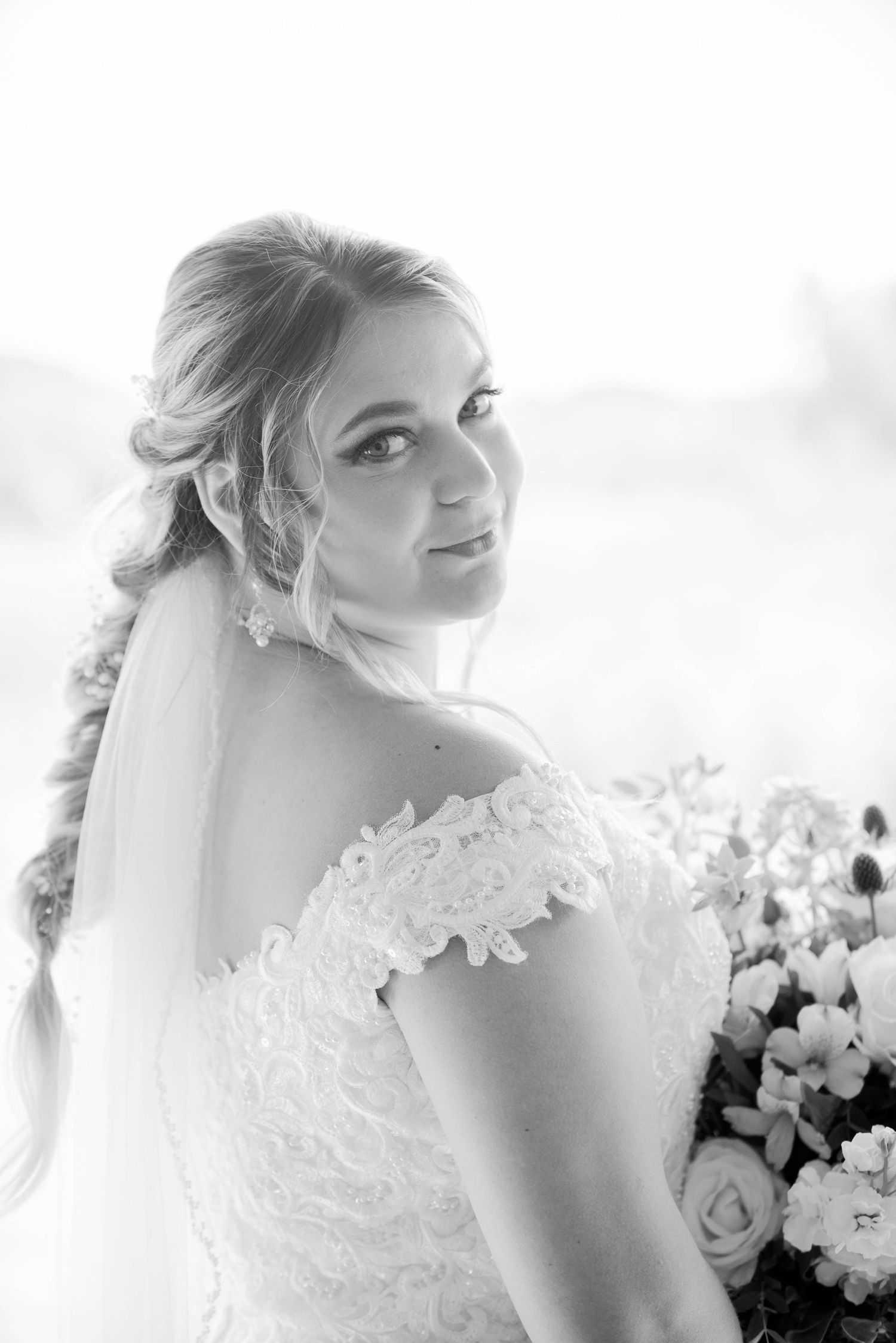 Close-up details of delicate lace and beading on a white wedding gown. Zimmerman MN Weddings