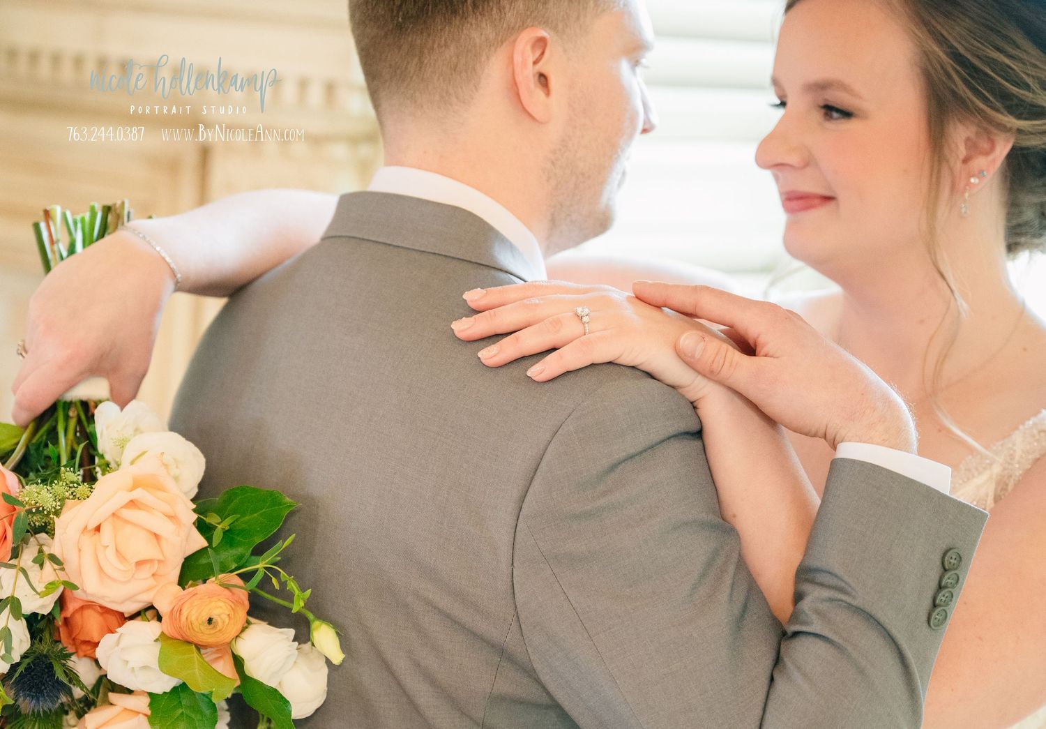 Bride resting her hand on groom's shoulder holding a peach floral bouquet on their wedding day. Crooked Willow Osakis