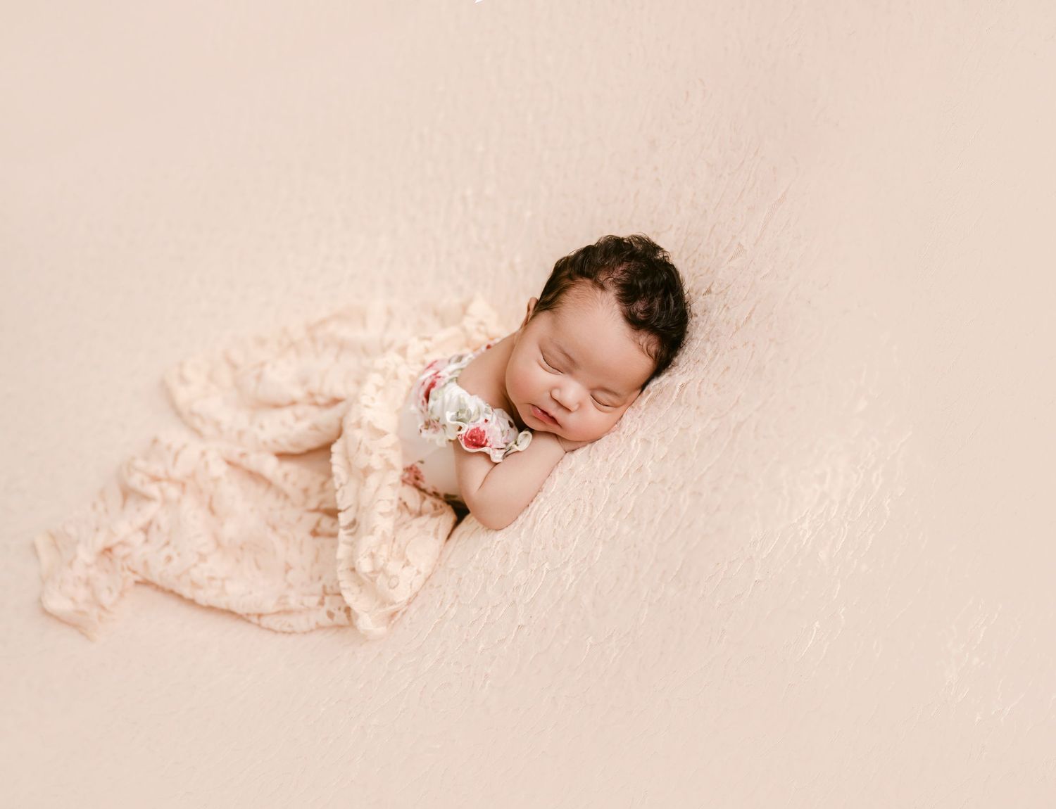 St Cloud newborn Photos of Sleeping newborn baby girl in lace outfit on cream backdrop.