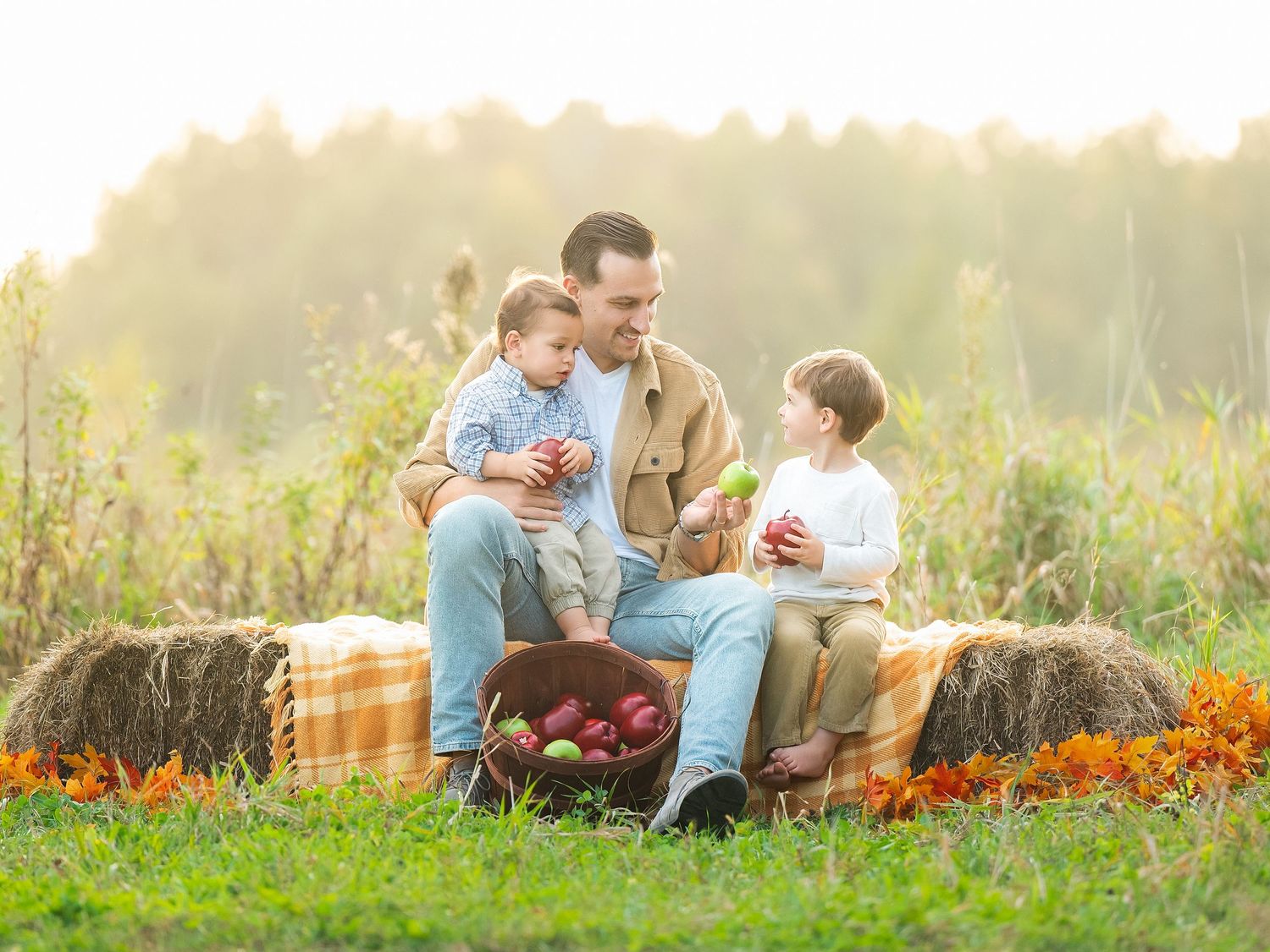 In central Minnesota a People enjoying a picnic in a flower garden during sunset with a wooden basket and blanket.