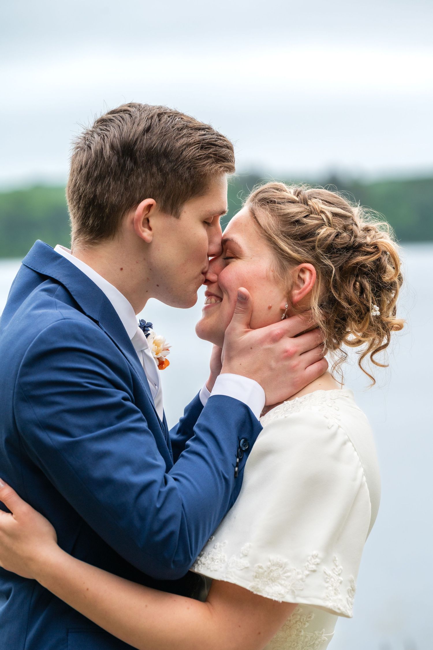 Multiple angles show a romantic wedding kiss between a couple in classic blue suit and white dress.