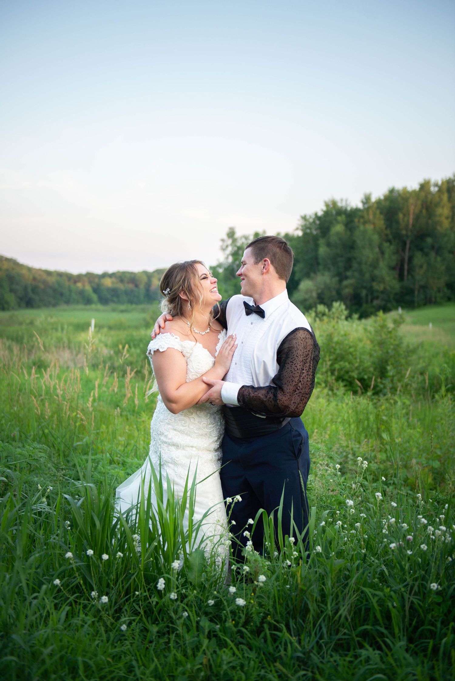 Romantic couple's portraits in a wildflower meadow at dusk. Zimmerman MN Weddings