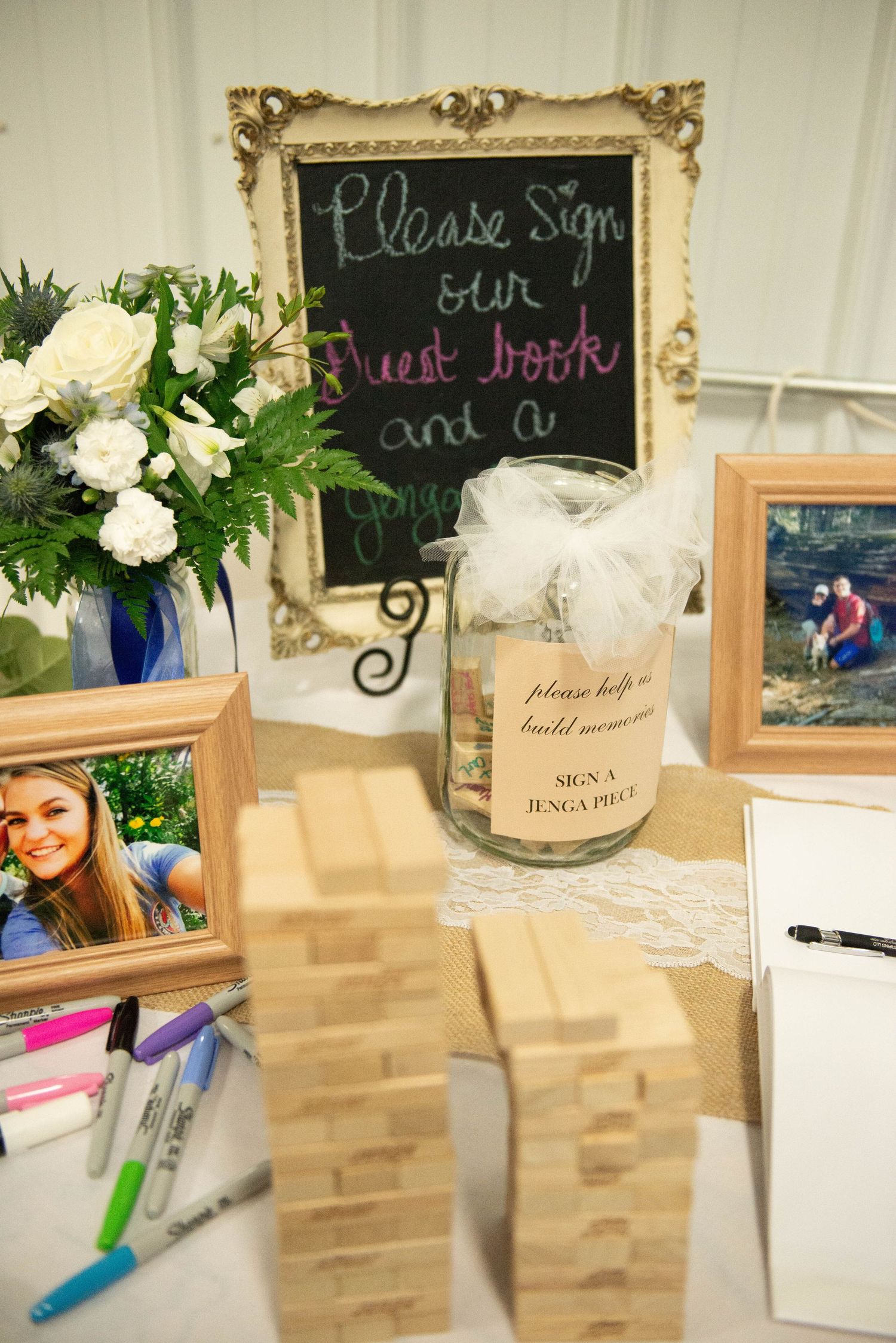 Wedding guest book table with vintage frame chalkboard sign, floral arrangement and signing materials. Zimmerman MN Weddings
