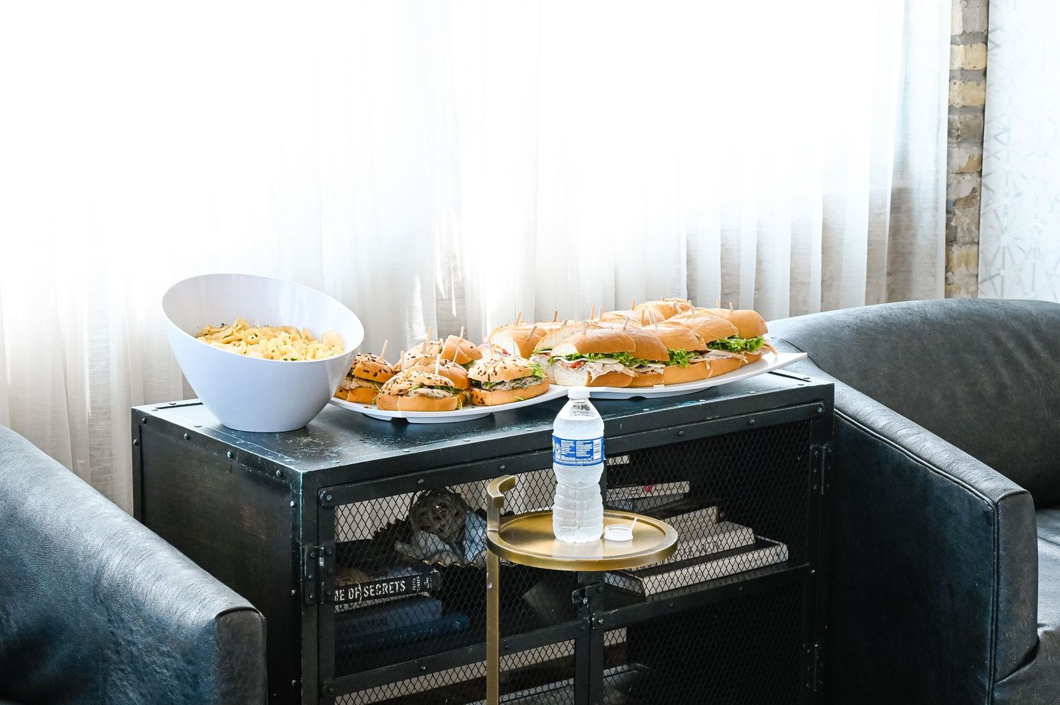 Casual wedding day snacks and refreshments arranged on a dark coffee table.