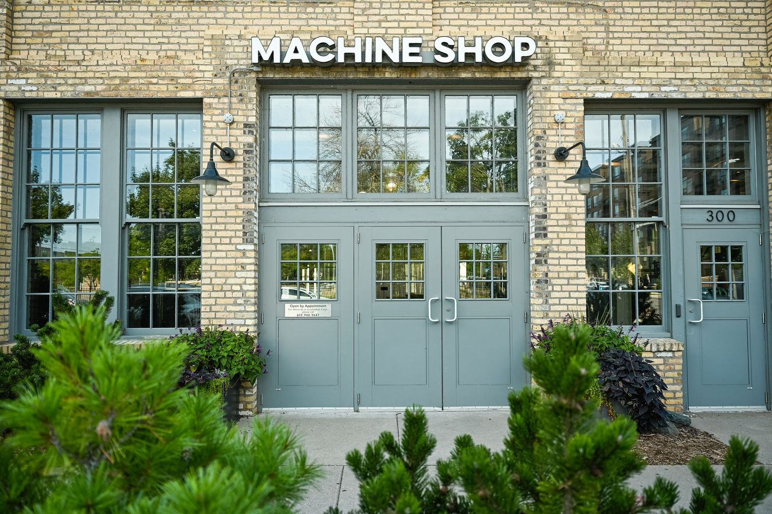 Historic Machine Shop building exterior with blue-grey doors and cream brick facade.