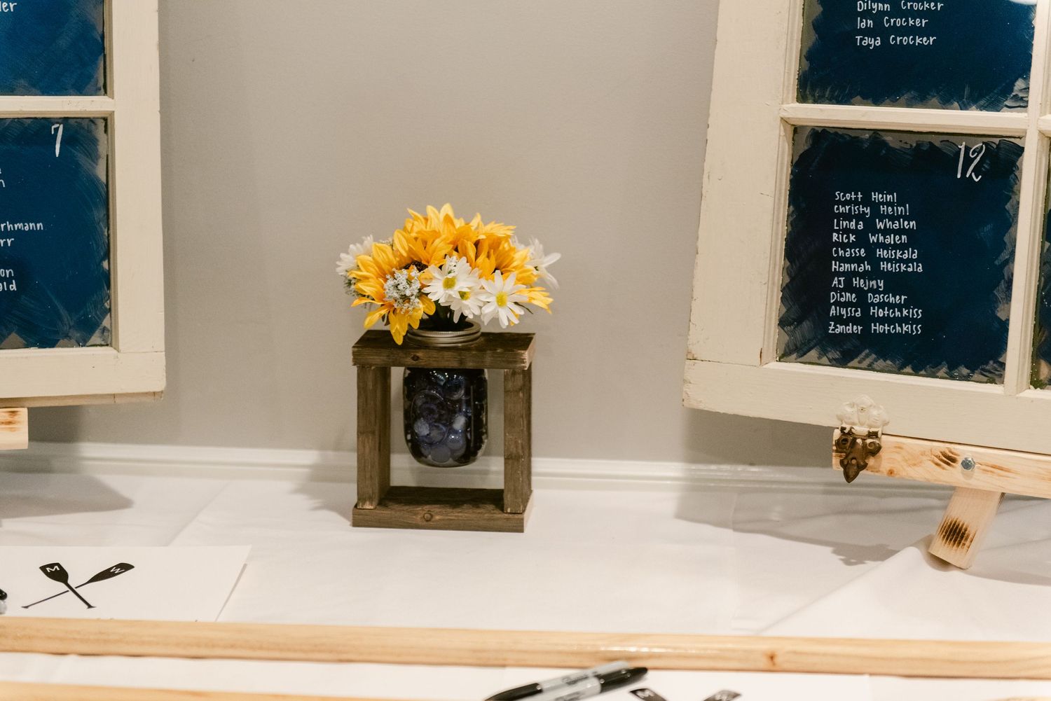 Central MN Wedding Photos | Rustic wooden centerpiece with sunflowers and daisies displayed between vintage window frames.