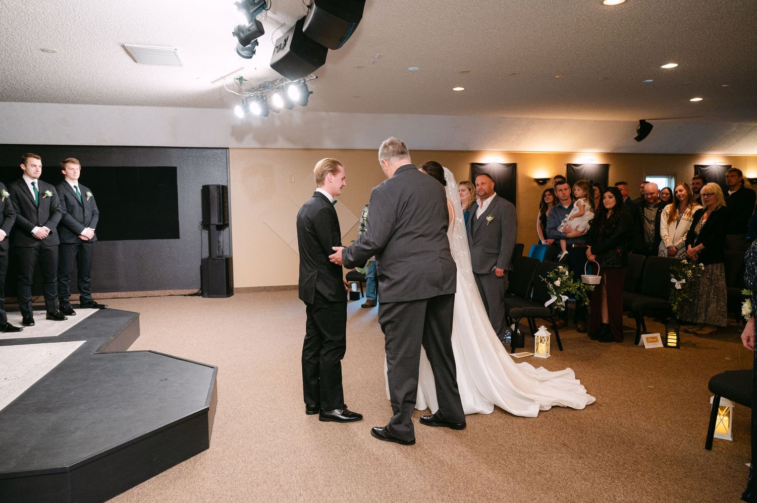 Side view of wedding ceremony space showing raised platform and guest seating area.