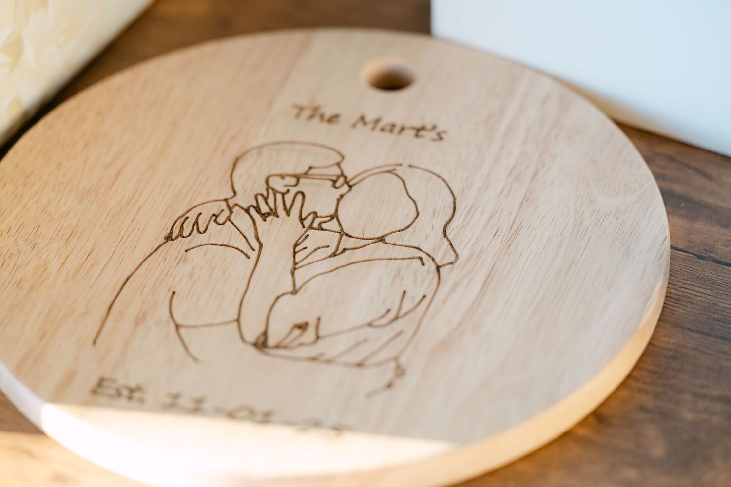 Wooden coasters with laser-engraved animal designs displayed on a dark wooden surface.