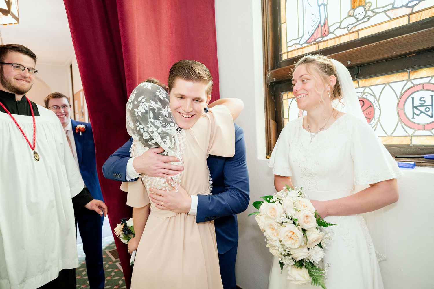 Wedding ceremony celebration in church interior with traditional decorations.