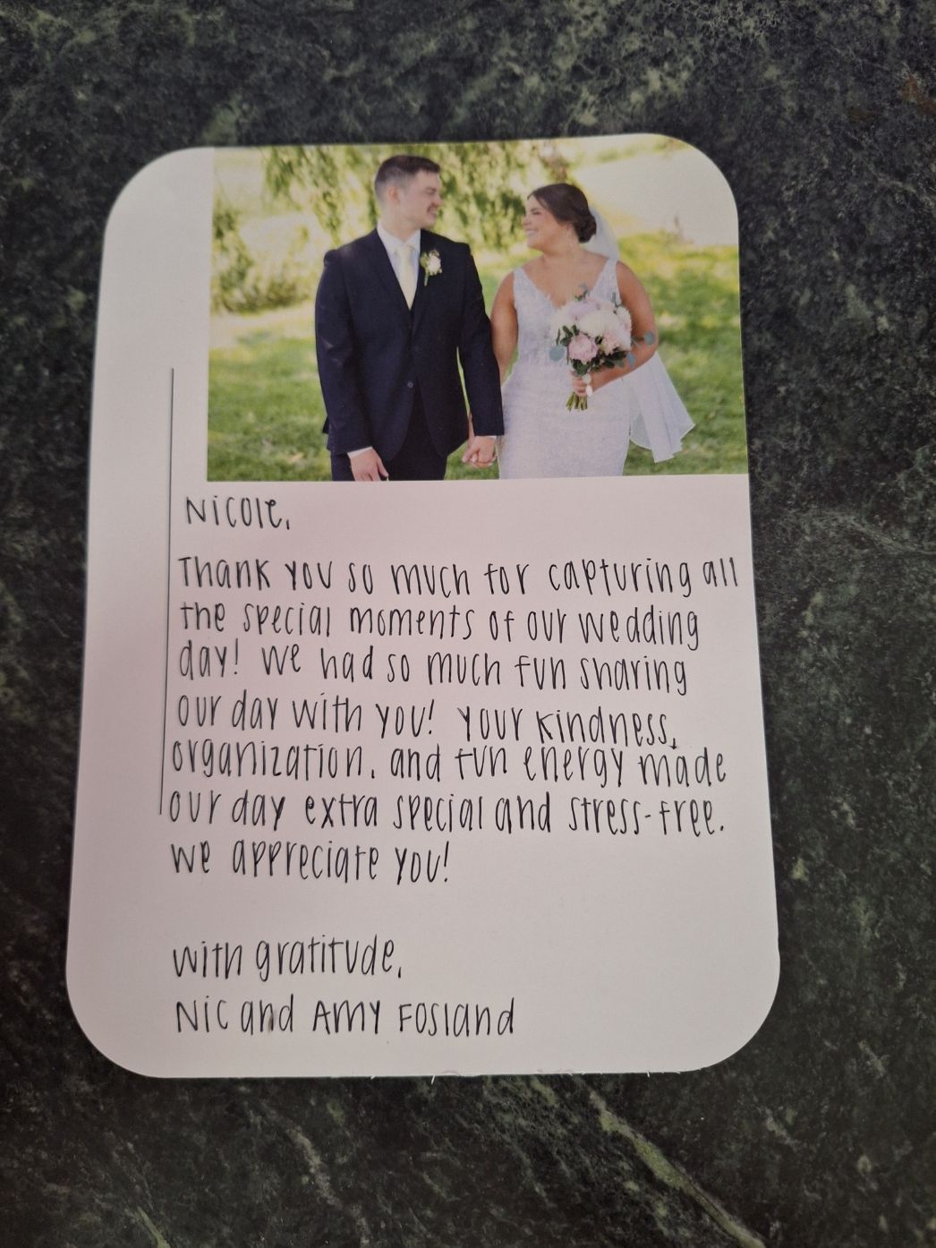 Wedding thank you card featuring couple photo and handwritten note expressing gratitude to photographer Nicole from Nic and Amy Fosland.
