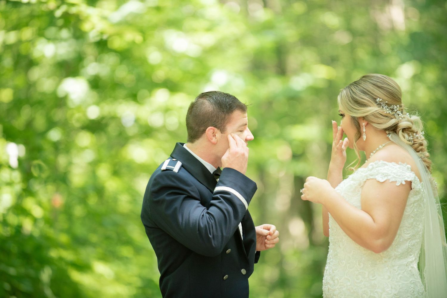 Emotional moment during wedding ceremony as couple exchanges vows in woodland setting. Zimmerman MN Weddings