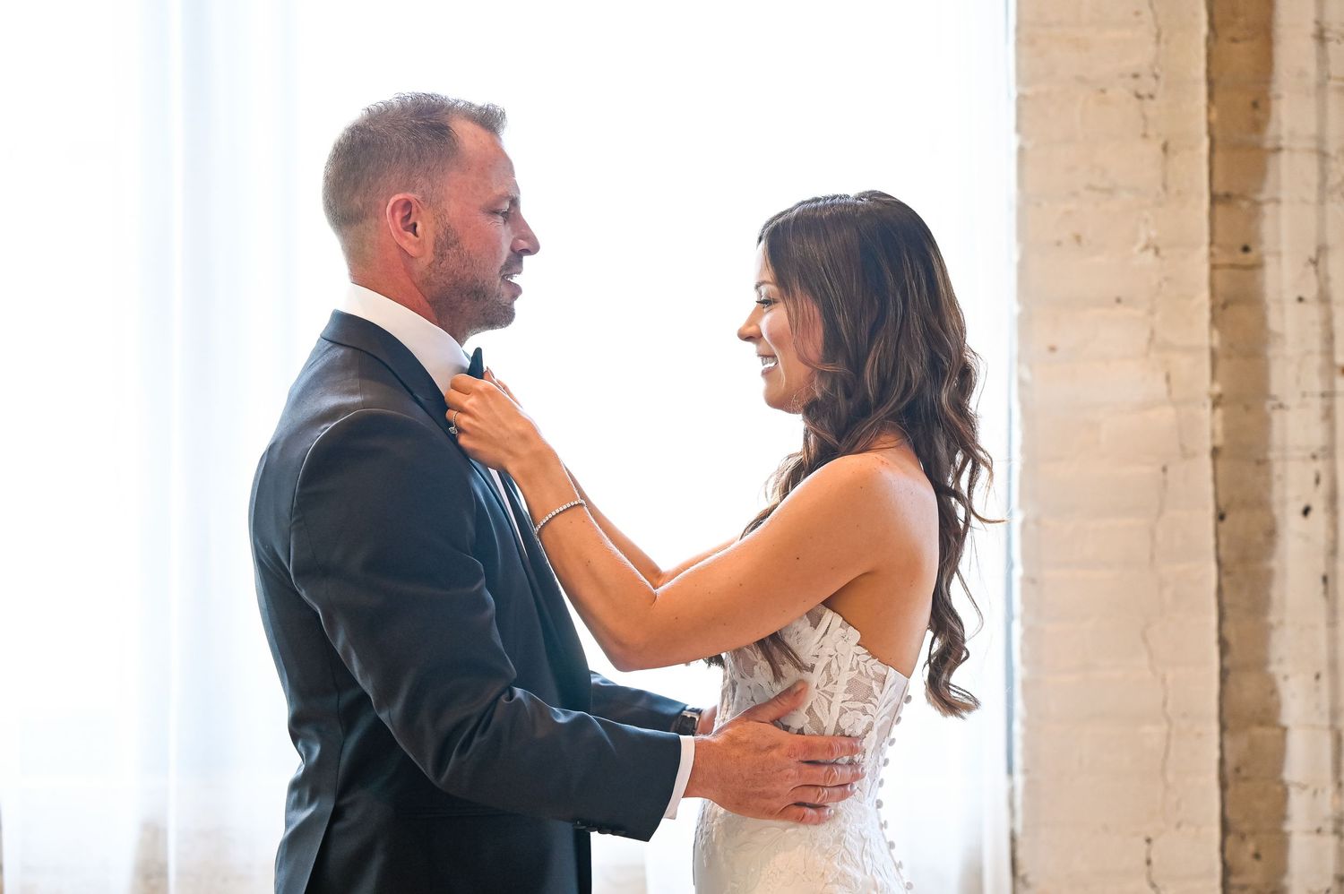 Romantic wedding couple shares intimate dance moves in an elegant indoor space.
