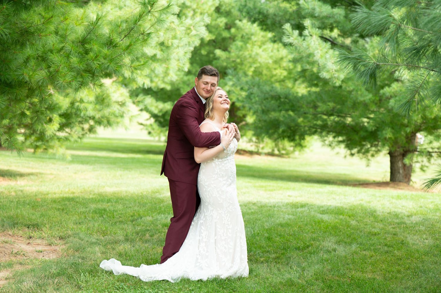 Elegant outdoor wedding ceremony setup with lush green trees in the background.