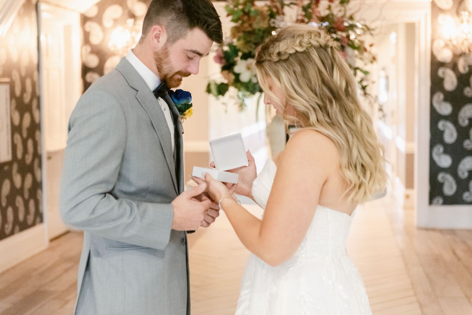 Central MN Wedding Photos | Groom opens wedding gift box from bride during romantic first look exchange.