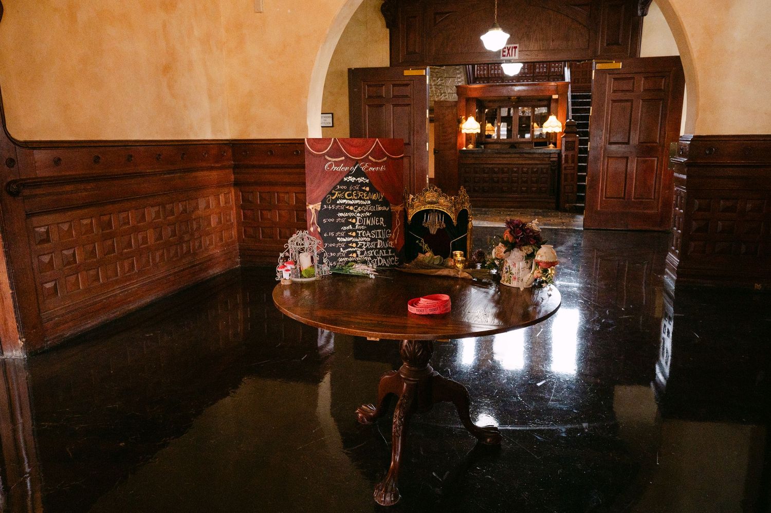 Wedding at The Historic Concord Exchange Minneapolis MN. Elegant interior with dark wood paneling, marble table, and decorative items.