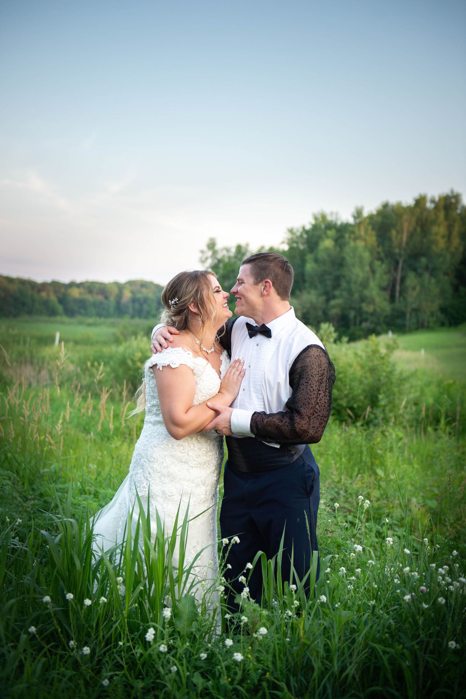 Romantic wedding portrait in a wildflower meadow at sunset with natural lighting. Zimmerman MN Weddings
