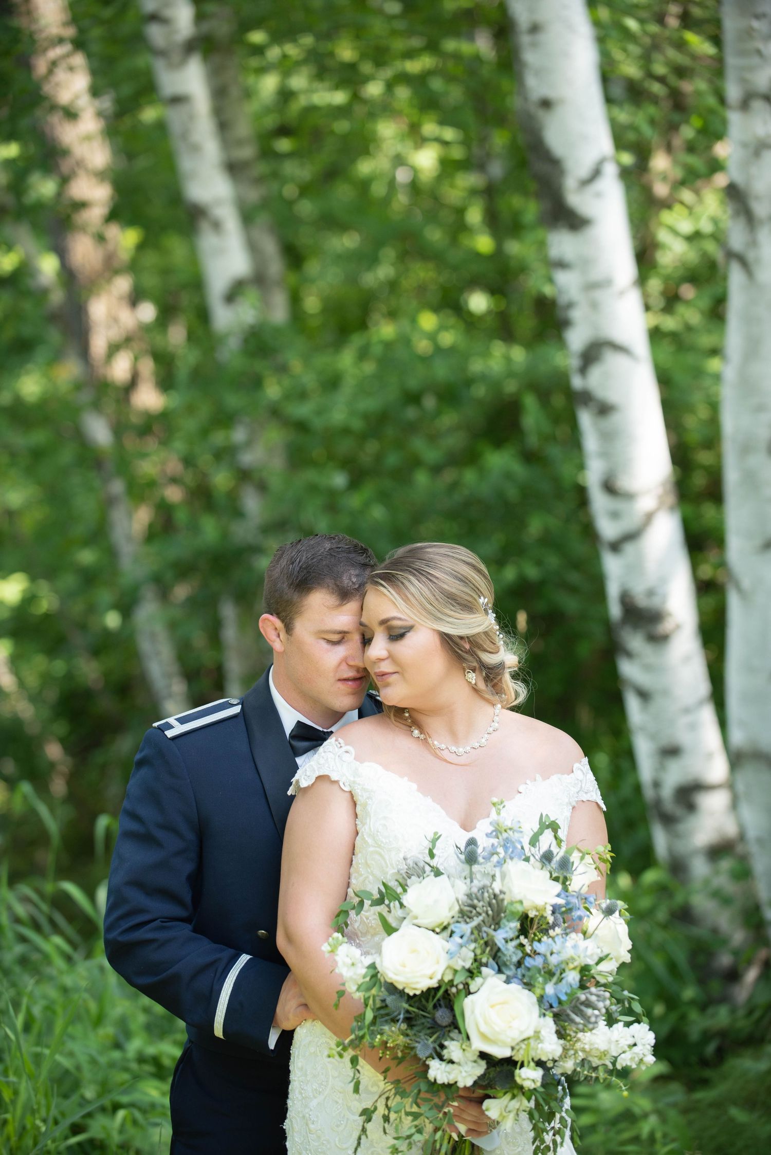 A romantic wedding portrait set among birch trees in a lush forest setting. Zimmerman MN Weddings