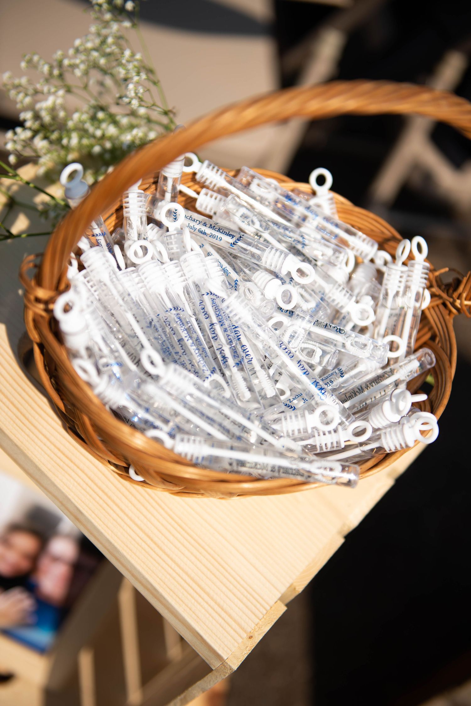 Small rolled paper messages arranged in a rustic wooden basket. Zimmerman MN Weddings