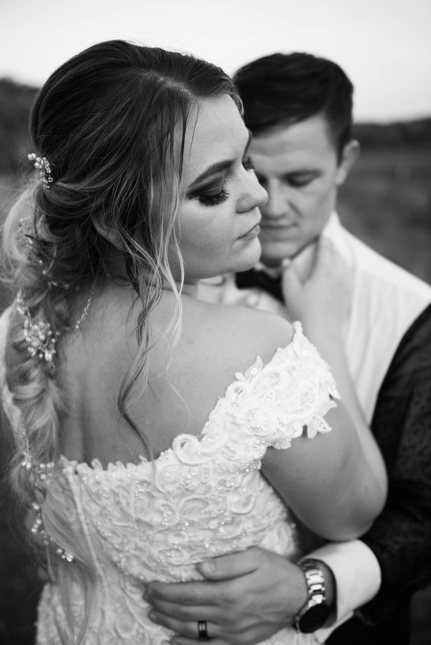 An intimate black and white portrait captures a romantic moment between newlyweds.  Zimmerman MN Weddings