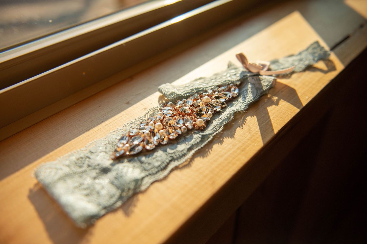 A vintage-style bridal hair accessory with crystal details displayed on gray fabric. Zimmerman MN Weddings