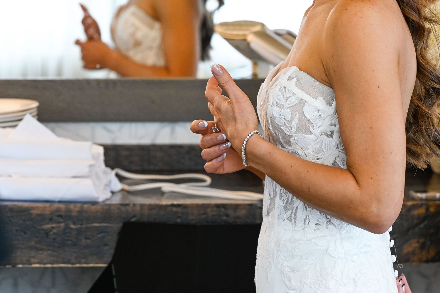 Close-up of bridal preparations showing delicate lace dress details.