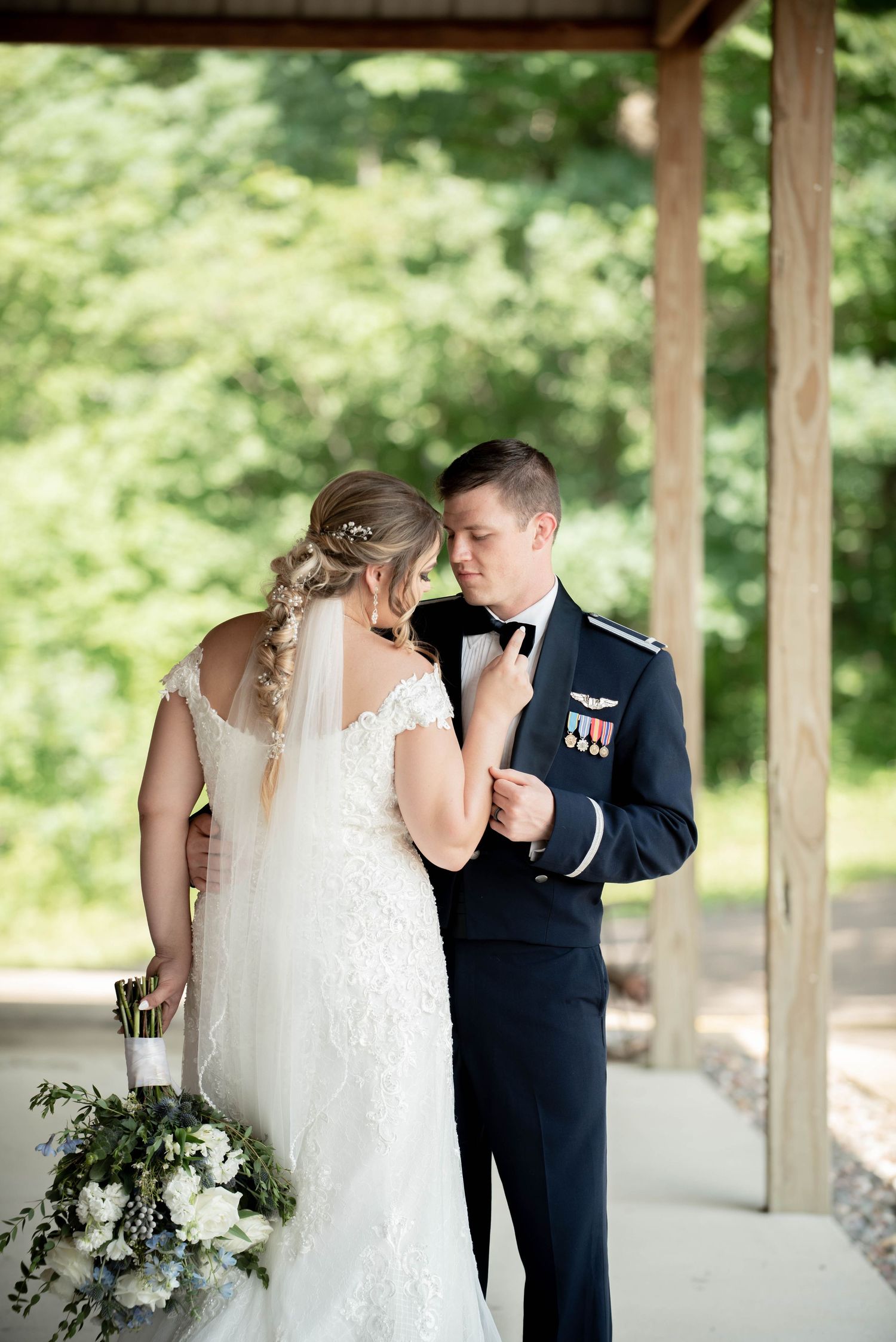 Couple shares intimate first look moment under wooden pavilion. Zimmerman MN Weddings