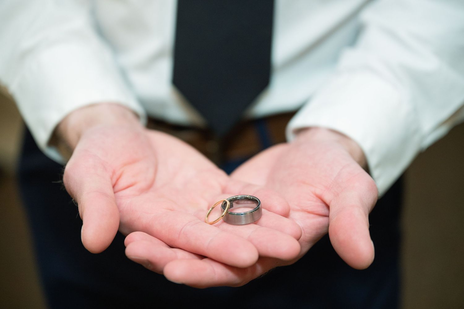 A sequence of hands performing a magic trick with a small coin appearing and disappearing between fingers.