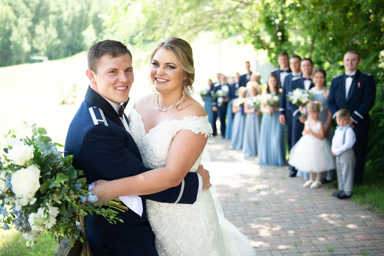 Wedding celebration with guests lined up along a garden pathway. Zimmerman MN Weddings