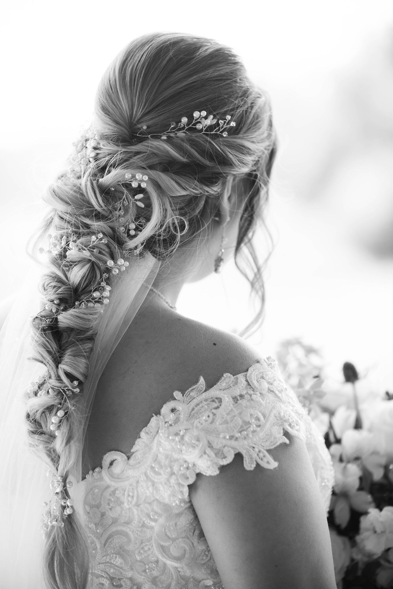 Elegant bridal hairstyle with delicate floral accessories woven into a braided updo. Zimmerman MN Weddings