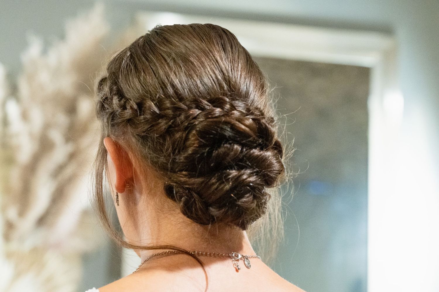 Elegant braided updo hairstyle with intricate woven plaits for a wedding or formal event.
