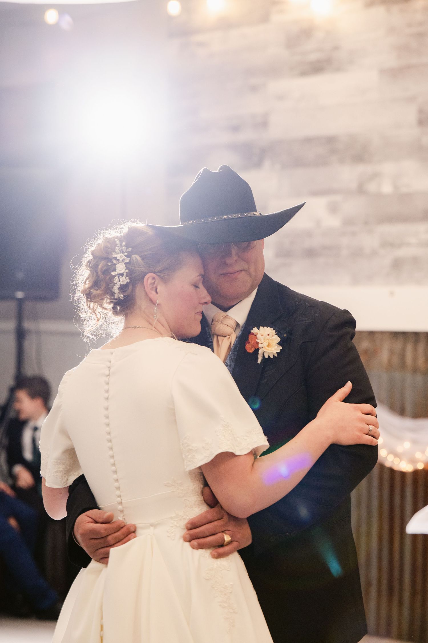 A romantic progression of wedding dance photos showing a couple embracing in soft lighting and formal attire.