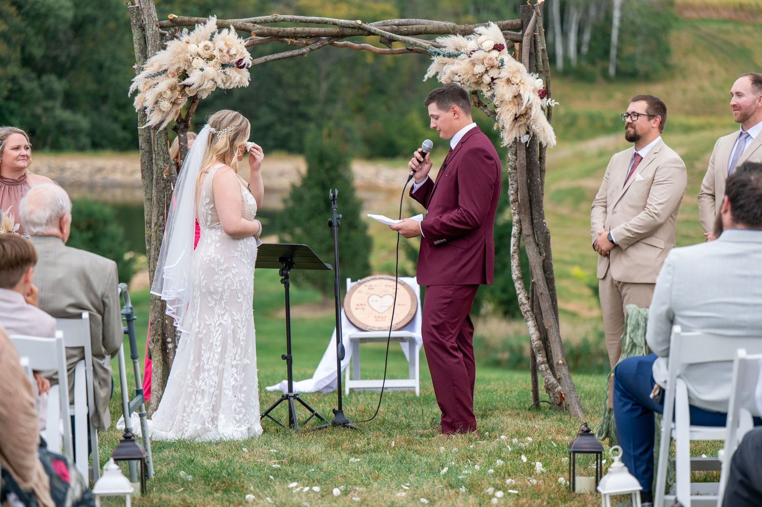 Wedding couple shares a romantic first look moment in an outdoor garden setting.