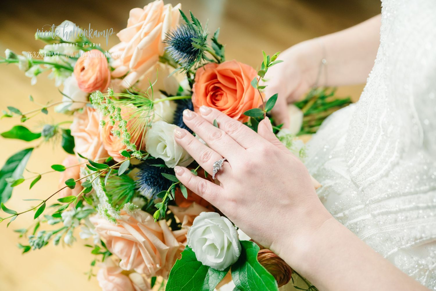 Elegant peach and coral floral wedding bouquet with greenery and roses against a neutral background.