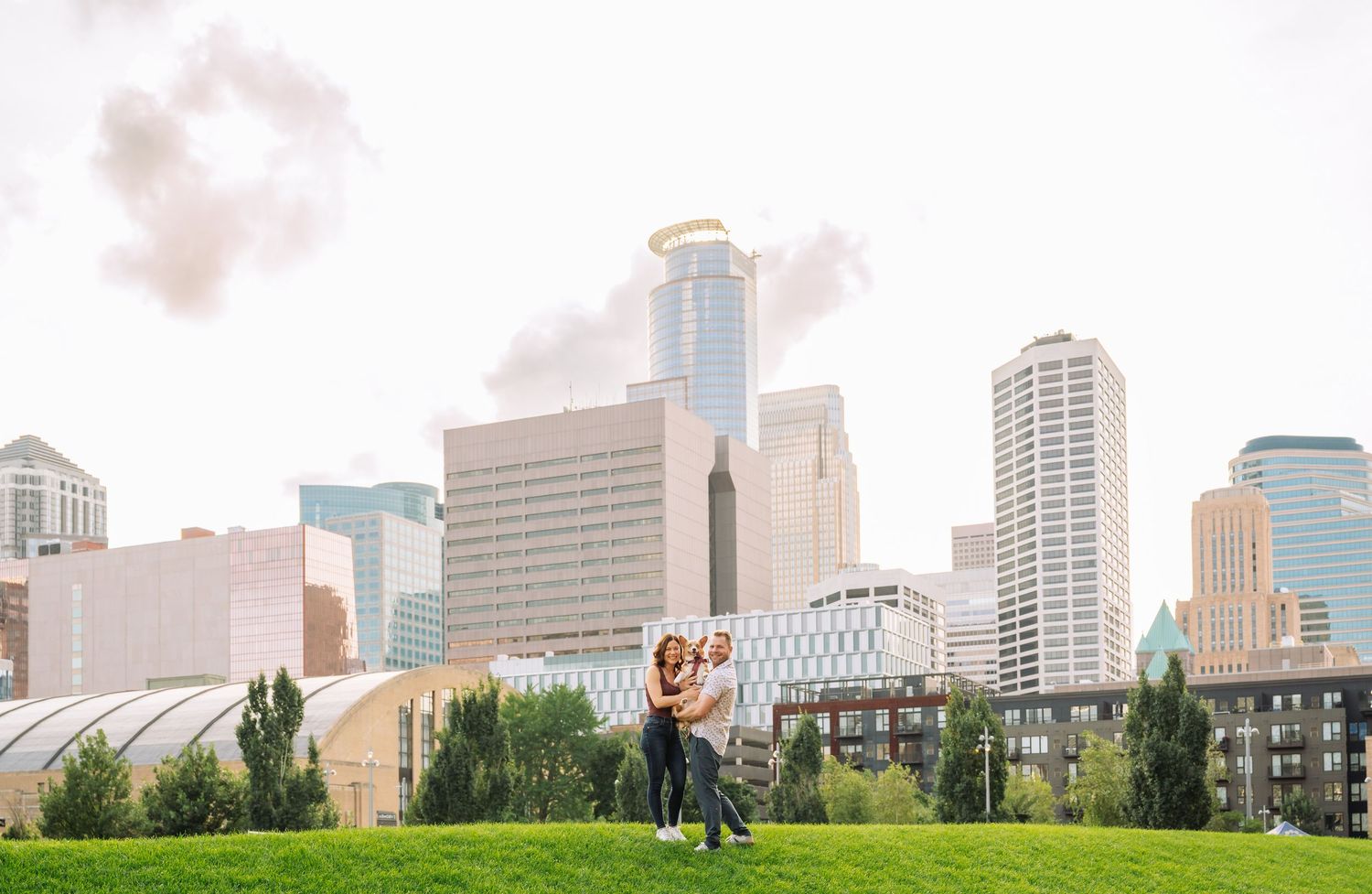 Minneapolis skyline panorama view showing modern buildings against a cloudy sky.