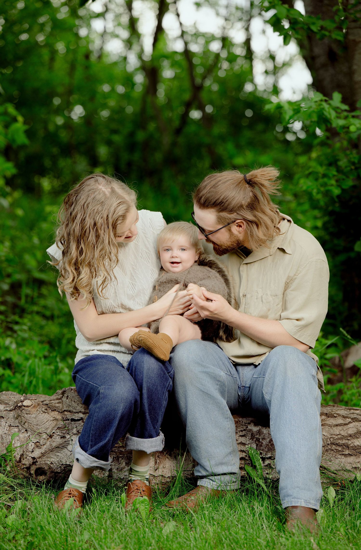 Three candid moments of affection shown on a grassy forest floor in casual outdoor clothing.