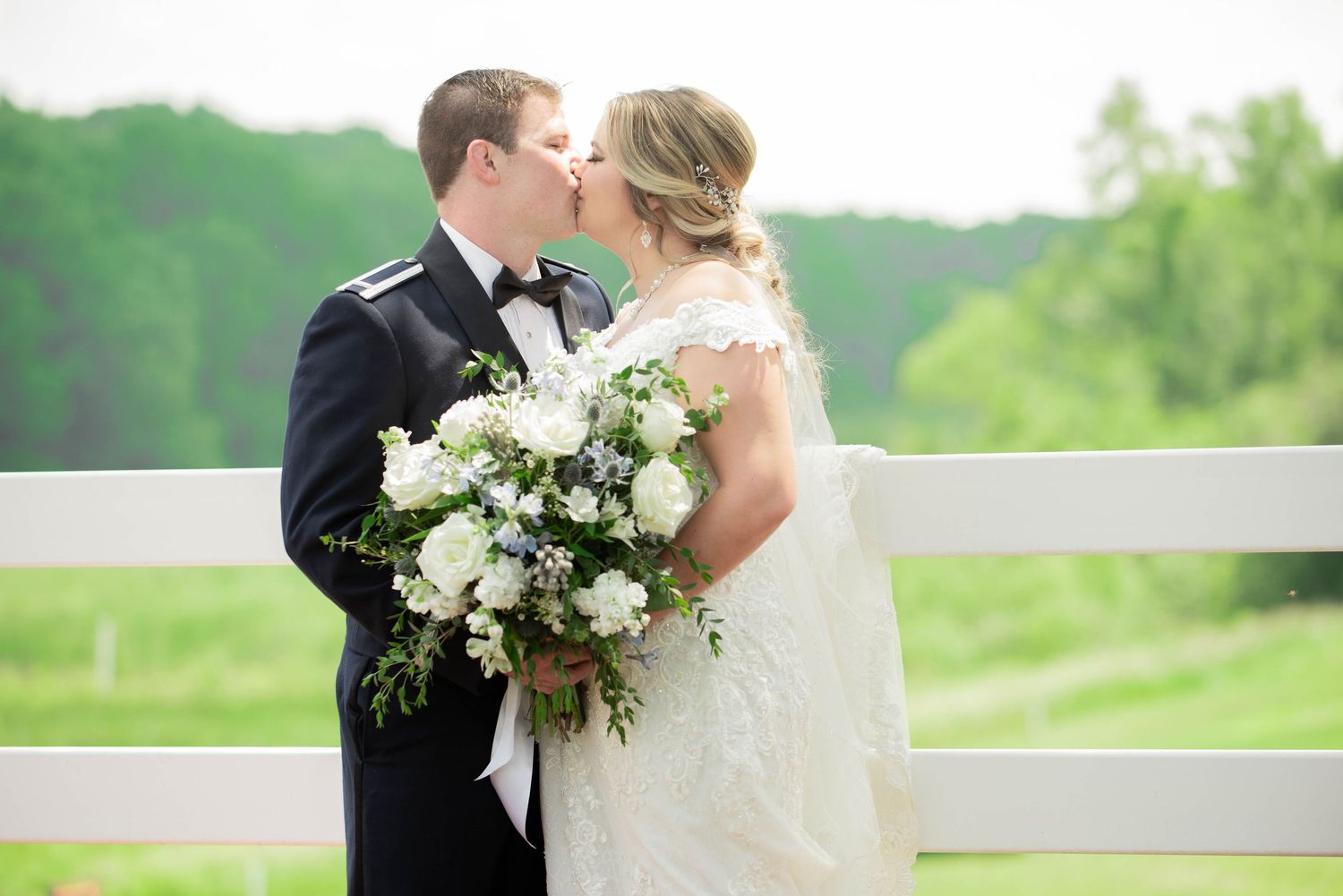 Couple sharing a romantic moment on an outdoor terrace during their wedding. Zimmerman MN Weddings