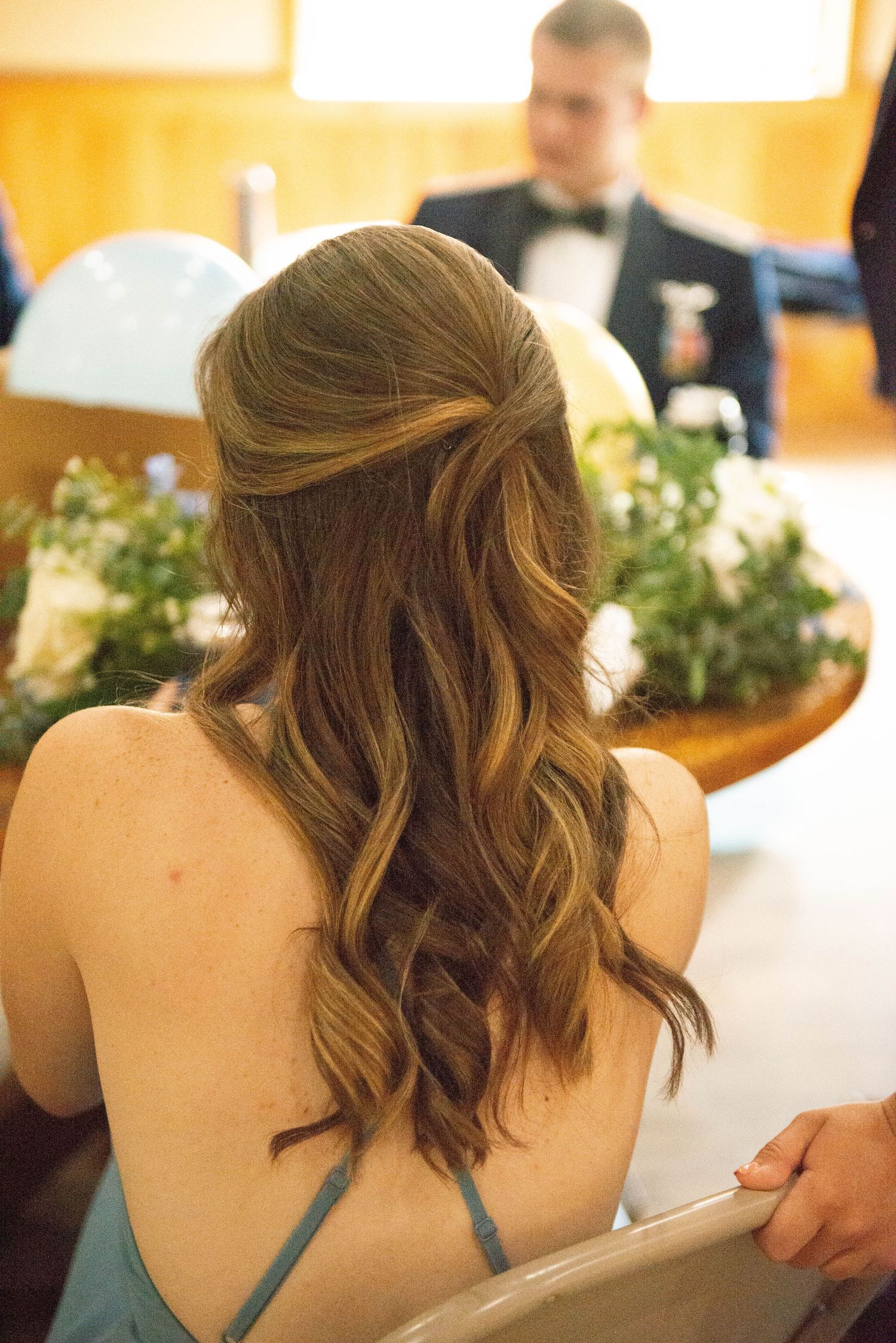 Back view of elegant hairstyle with teal dress straps visible. Zimmerman MN Weddings