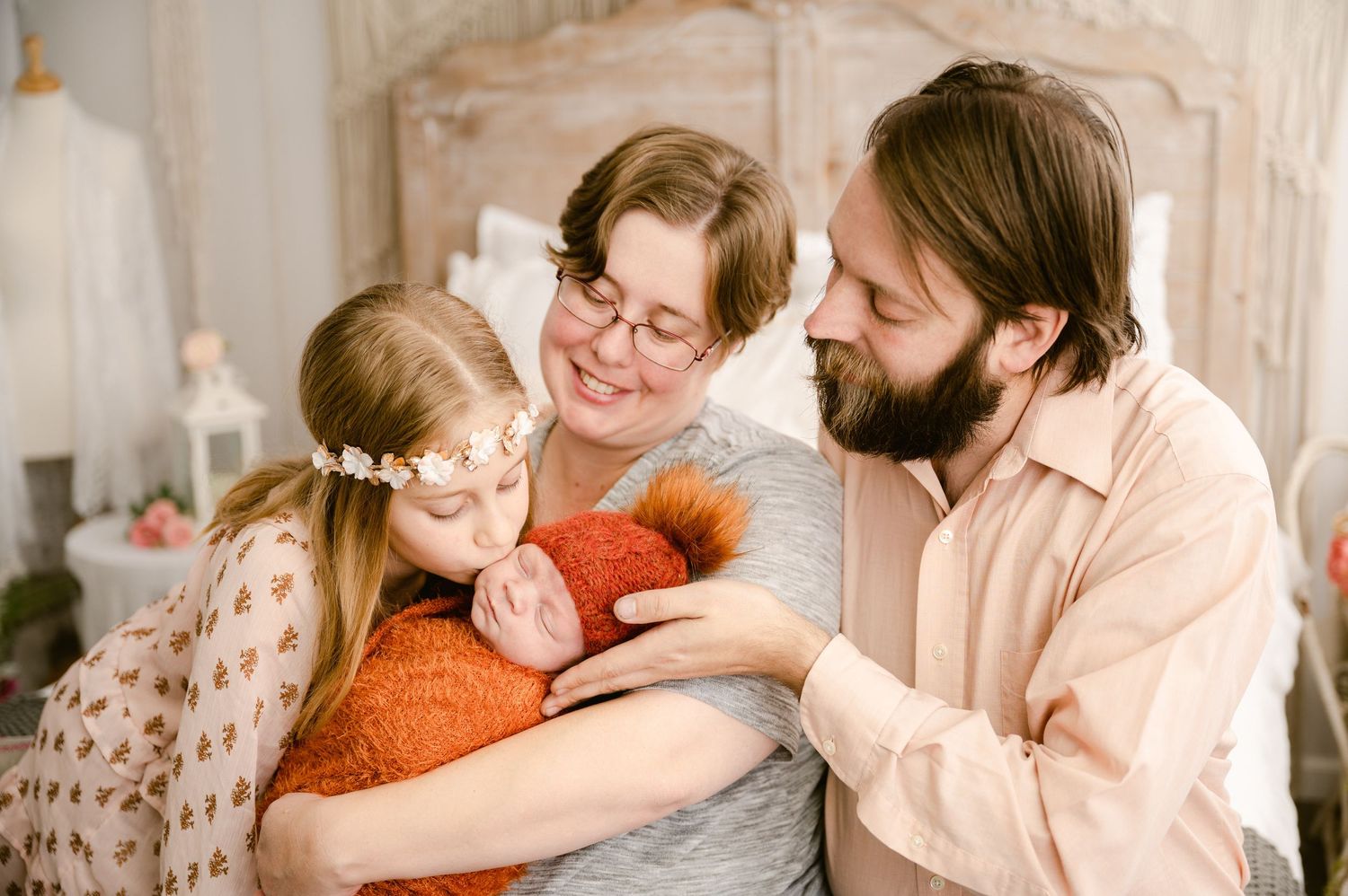 Loving family sharing a tender moment together on a couch at home in warm earthy tones.