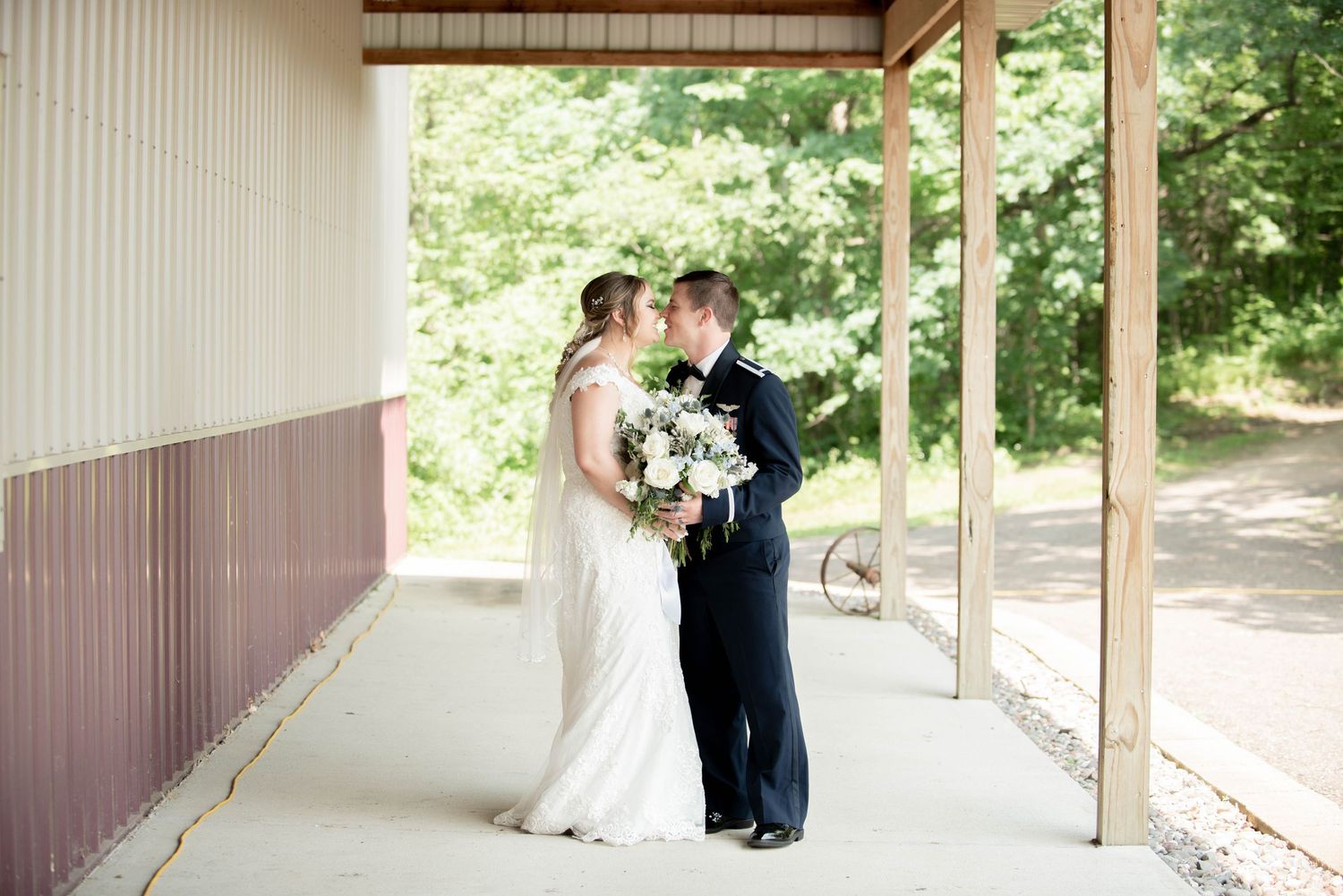 An intimate wedding moment captured on a covered porch of a rustic building. Zimmerman MN Weddings