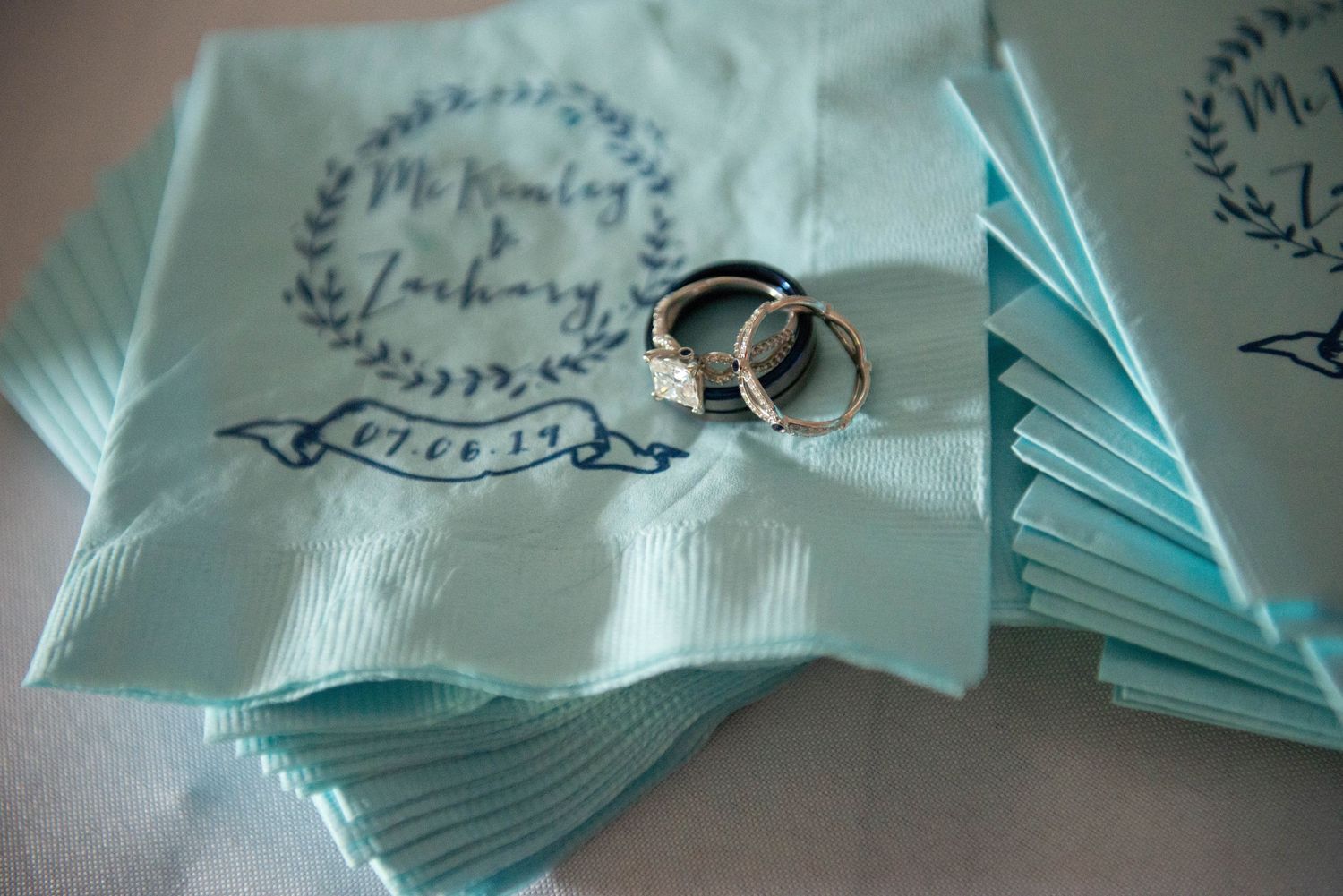Light blue wedding favor bags arranged in neat rows with decorative logo printing. Zimmerman MN Weddings